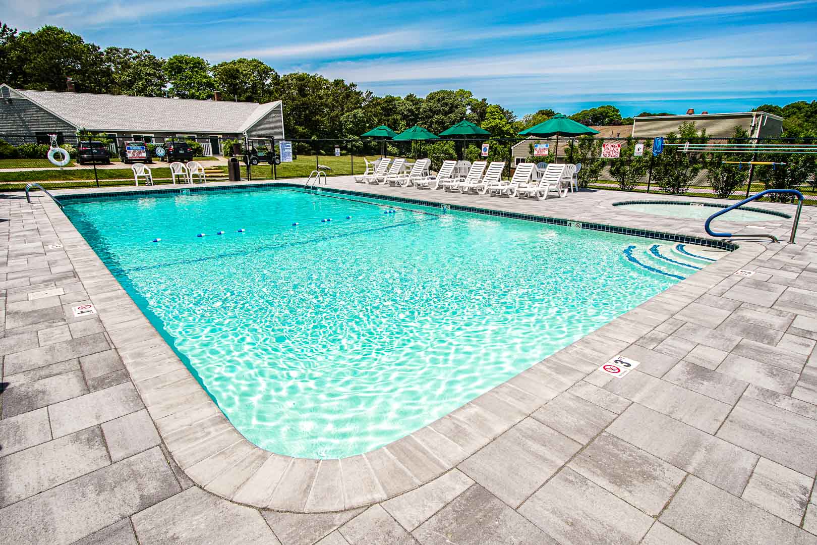 A crisp and clean outdoor swimming pool at VRI's Brewster Green Resort in Massachusetts.